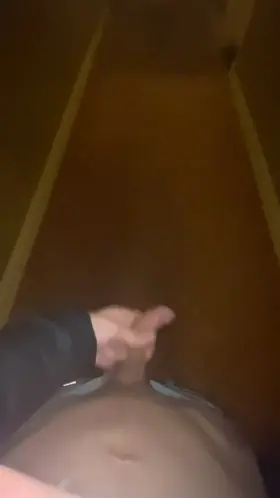 A short but risky jerk in a hotel hallway, rubbing a little bit of precum on a random door handle.