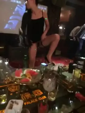 Chinese Waitress serving a bottle of beer