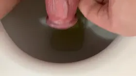 Quick piss after jerking my hard dick -- watch for the cum in my stream haha!