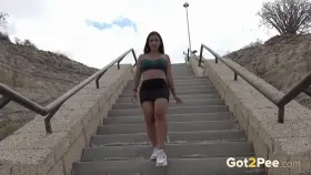 A cute European brunette decides to piss down some steps