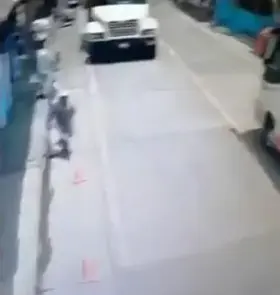 Man walking in street is run over while giving thumbs up