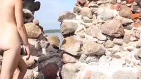 Naked And Cautious At The Castle Ruins While Tourists Are Behind The Wall