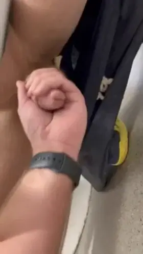 Could tell this dude was jerking off in the stall next to me by his shadow, so I invited him to put his dick in my hand. Jerked him understall until he shot his cum.