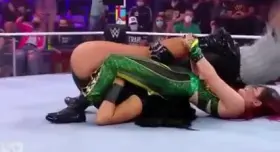 Persia Pirotta getting her legs pinned back as Io sits on her face