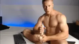 Muscle boy sucks a dildo