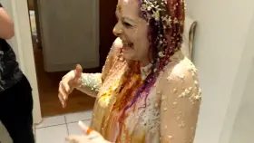 Danielle, all covered in food, admires herself in the mirror