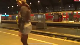 Cute German girl leaves a puddle on station platform
