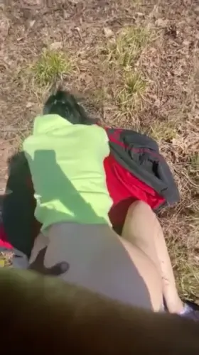 White girl stops to take a quick break during hiking trip with boyfriend