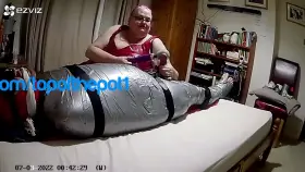 Post Orgasm by topofthepot1, A doxy and a Domme. Him, wrapped in pallet wrap, duct tape And strapped to the backboard.@02.20
