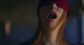 Blindfolded girl fingers herself and licks her own tit.