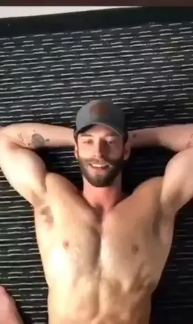 Who's this bearded cutie in a hat getting cum squirt all over his body?