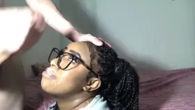 She smiles as he covers her face with his cum...