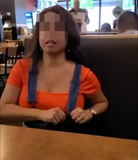 Asian having fun while waiting for food