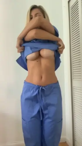 Sexy nurse stripping off her uniform