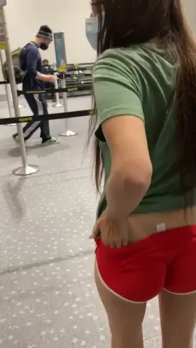 Showing off [her] ass & butt plug at the airport