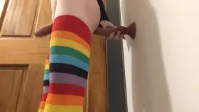 Rainbow slut riding knotted cock against the wall