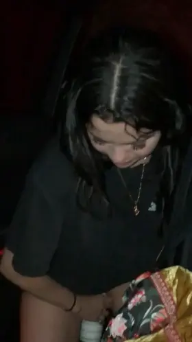 Selena pissing in a glass