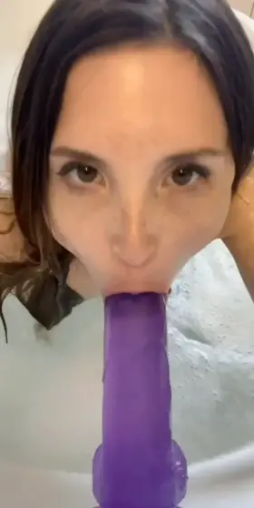 Piper sucking purple dildo.