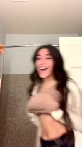 Hot brunette flashes her juicers in the bathroom