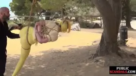 Latina suspended in rope bondage and disgraced like a pig in the park