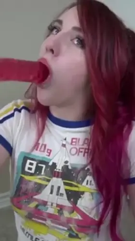 Girl choking on huge dildo.