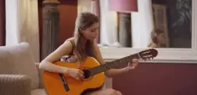 Playing her favorite instrument.