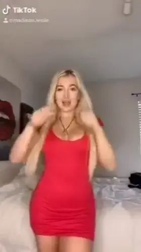 Blonde takes off red dress.