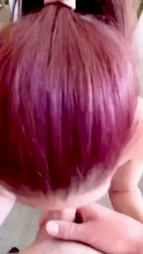 Purple haired babe swallowing his cock