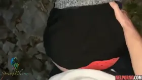 A girl in nature lifts up her black skirt and flashes her tight ass in red panties