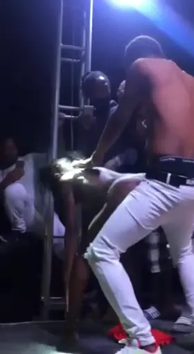 She gets topless on stage and gives the singer a steamy dance mid-concert