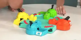 Two women playing hungry hungry hippos