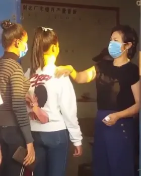 She has a thermometer in her hand.