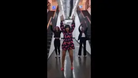 Angellica Bell jumping in a short dress