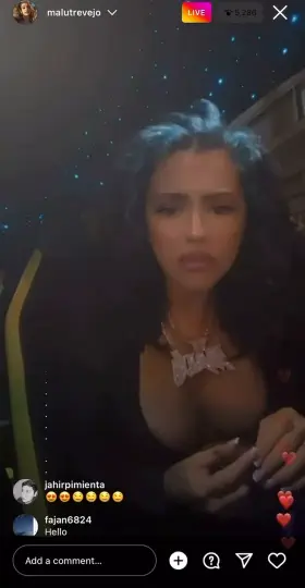 She's rolling a blunt on her live with her nipples out