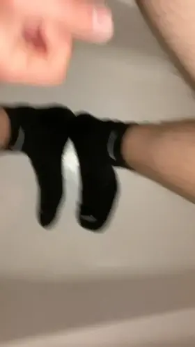 Releasing a load on my black Nike socked feet