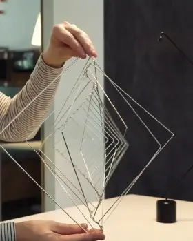 Girl fidgeting with a kinetic sculpture