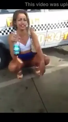 Carnival girl nonchalantly pees while talking on busy street