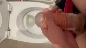 I pull my masturbator off my cock to take a piss