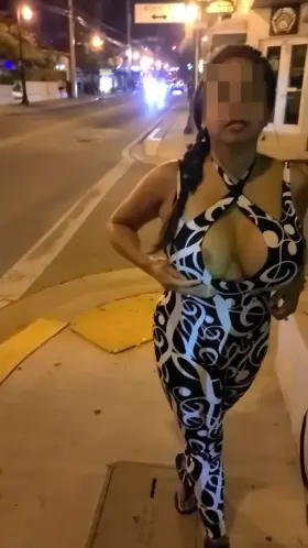 Asian teasing drivers as they pass by