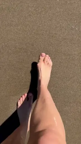 Watch my toes and soles press against the wet sand