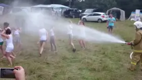 Girls in wet t-shirts having fun and flashing boobs