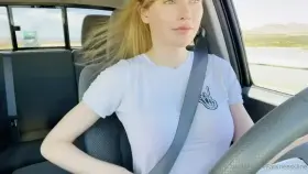 Cute girl taking off bra while driving