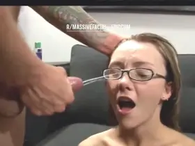 Nerdy slut gets sprayed with cum all over her face