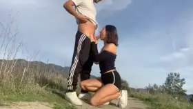 Busty petite gives a blowjob in the park