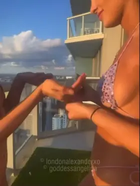 two college teens on a miami balcony soaking in oil 😈💦