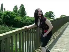 Raven-haired girl pissing on the bridge