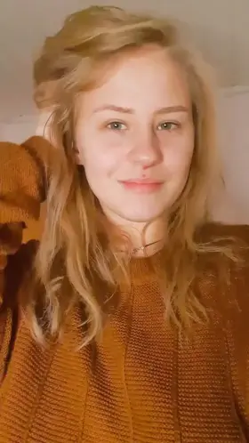 In and out of a modest brown sweater.