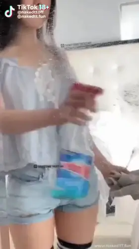 Tiktok video Woman probably East Asian, Wipes the mirror and goes naked.