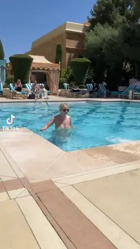 Busty blonde gets out of the pool
