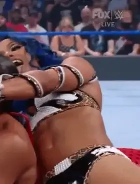 Sasha's abs flexing while giving Bianca Belair the Bank Statement.